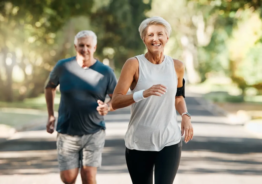Active seniors jogging together in a park.