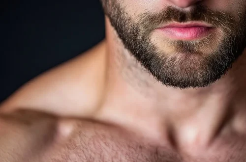 Close-up of a man's face and beard, showcasing facial hair.